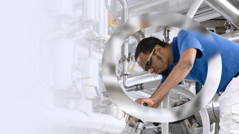 Production worker working on machinery