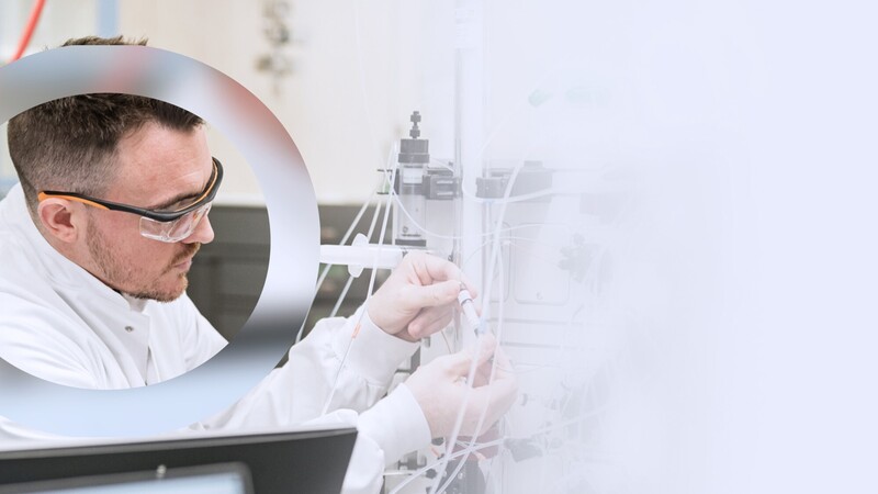 Research and development employee inspecting tube